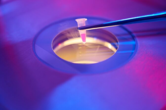 Embryologist places a small tube with biomaterial in cryostorage facility